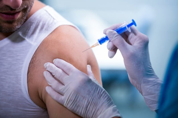 female doctor giving injection to patient