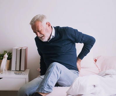 man suffering from ribbing pain waist pain