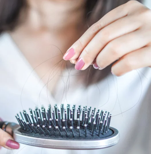 women removing hair from brush