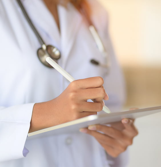 doctor writing on paper